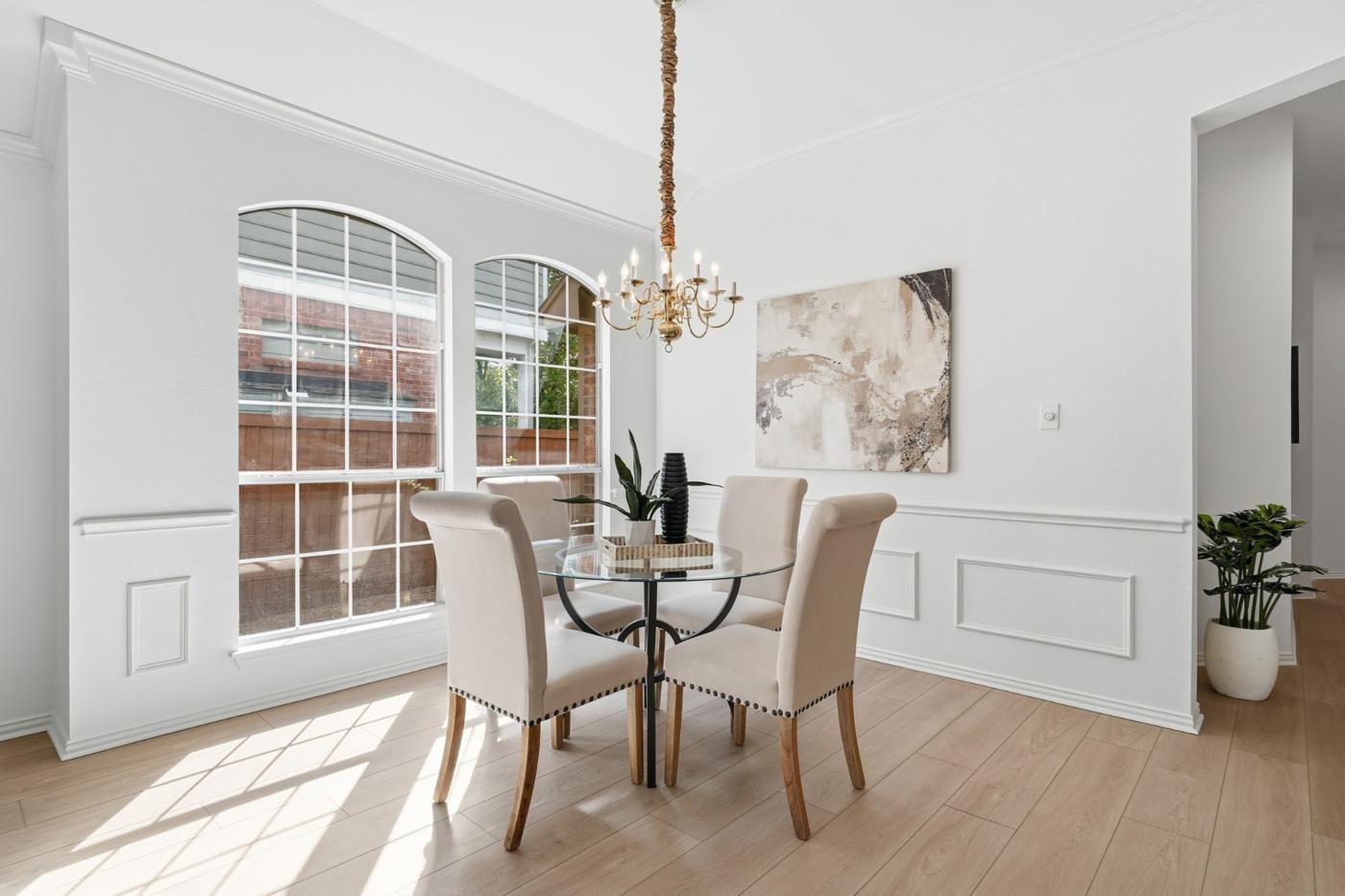 Formal dining room with wainscoting and arched windows