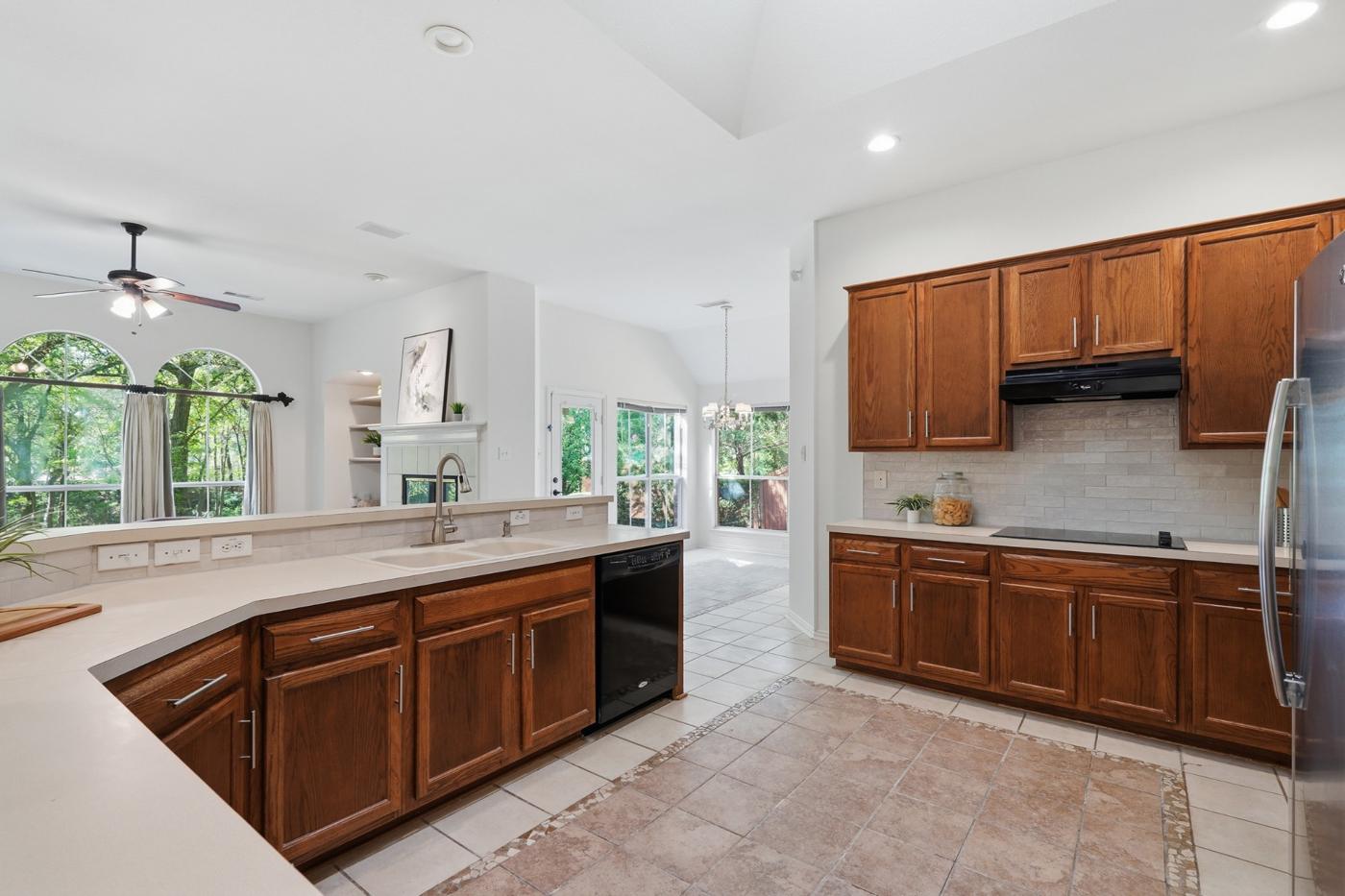 Kitchen with wood cabinets, cooktop, and counter space
